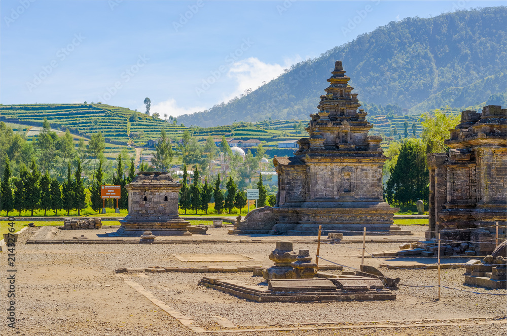Old hindu-buddhist carved stone temple in Dieng Plateau archeological site, in Java, Indonesia