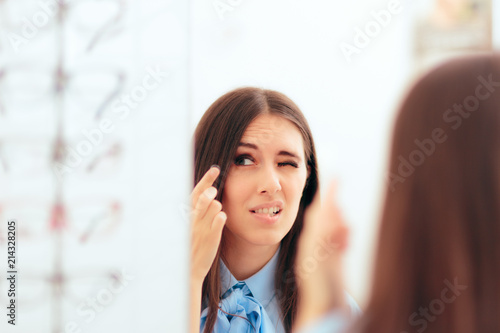 Fototapeta Naklejka Na Ścianę i Meble -  Woman Having Trouble Putting On Contact Lenses 