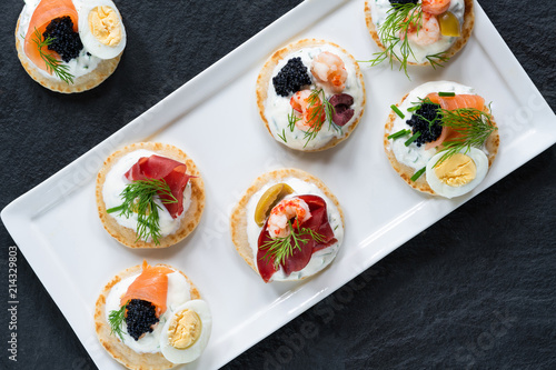 Принти на полотні Selection of cocktail blinis with salmon, cured bresaola, crayfish, caviar, quai