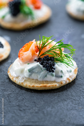 Cocktail blinis with crayfish, caviar and sour cream - gourmet party food idea