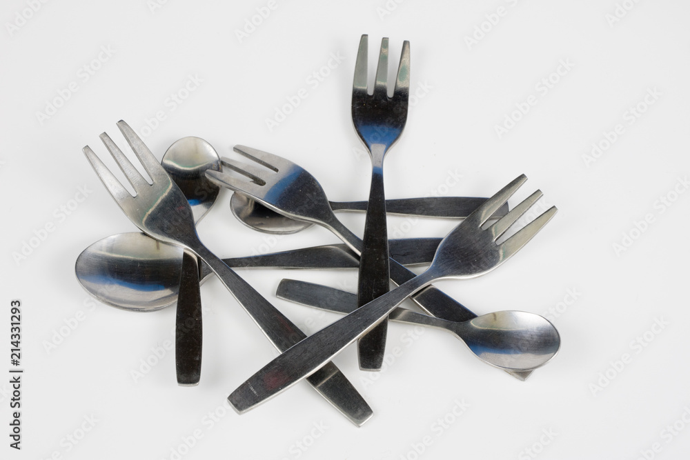 Cutlery arranged on a white kitchen table. Accessories for kitchen and restaurant use. Cutlery arranged on a white kitchen table. Accessories for kitchen and restaurant use.