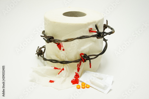 Treatment of acute hemorrhoids. Toilet paper with barbed wire, blood, tablets.