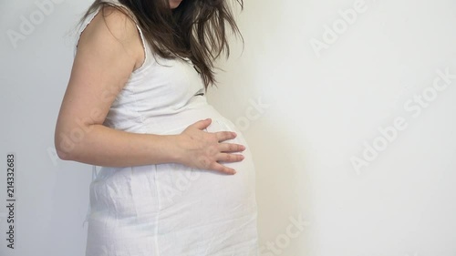Pregnant woman caressing her belly, waiting miracle of birth, purity feeling, close up, detail photo