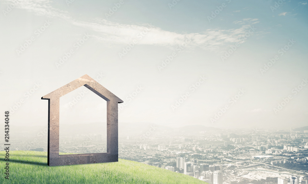 Conceptual image of concrete home sign on hill and natural lands Conceptual image of concrete home sign on hill and natural lands