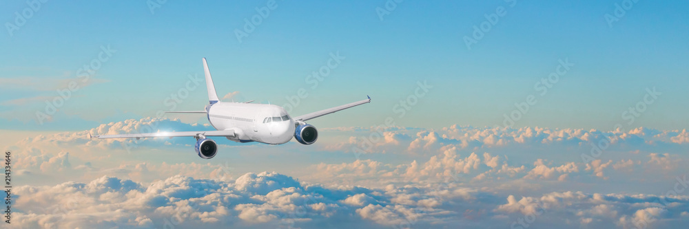 Passenger aircraft cloudscape with white airplane is flying in the evening sky cumulus clouds, panorama view.