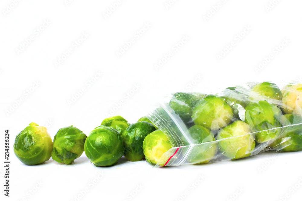 Plastic bag with frozen brussel sprouts isolated on white. Vegetable preservation Plastic bag with frozen brussel sprouts isolated on white. Vegetable preservation