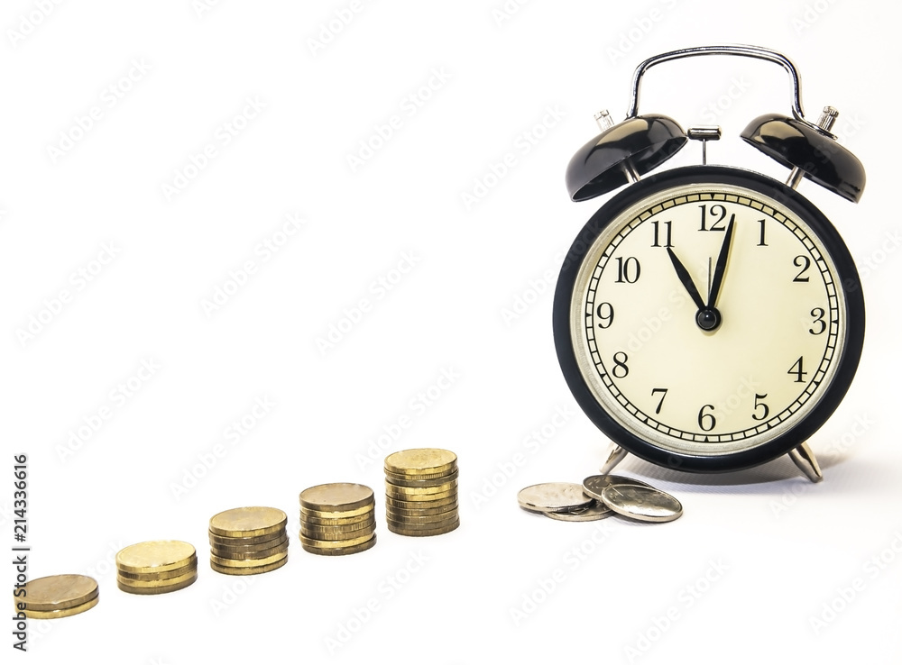 Folded coins next to a retro-alarm clock on a white background, the concept of saving time and money in the future. Folded coins next to a retro-alarm clock on a white background, the concept of saving time and money in the future.