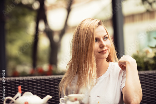 Woman having lunch in the first day of the summer dresses with a black jacket and a simplet white shirt talking with her friend. photo