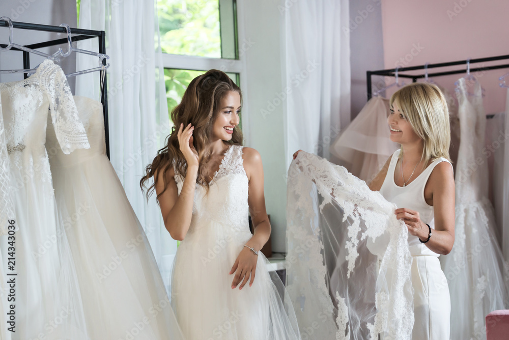 Bride and friends shopping for wedding gown