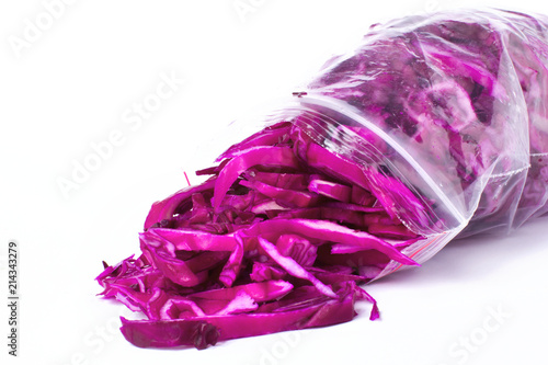 Plastic bag with frozen red cabbage slices  isolated on white. Vegetable preservation