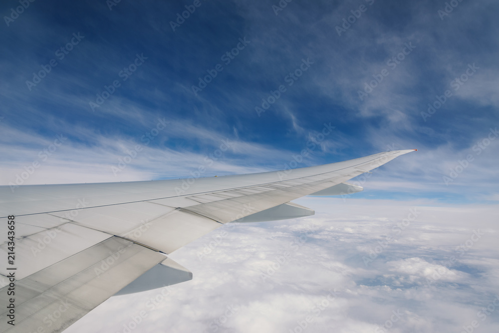 Wing of an airplane flying above the clouds. Wing of an airplane flying above the clouds.