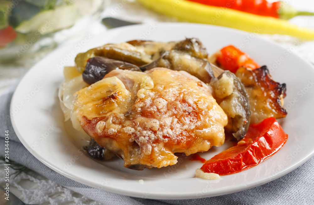 Traditional rustic stew of chicken and vegetables on plate with tomatoes, peppers