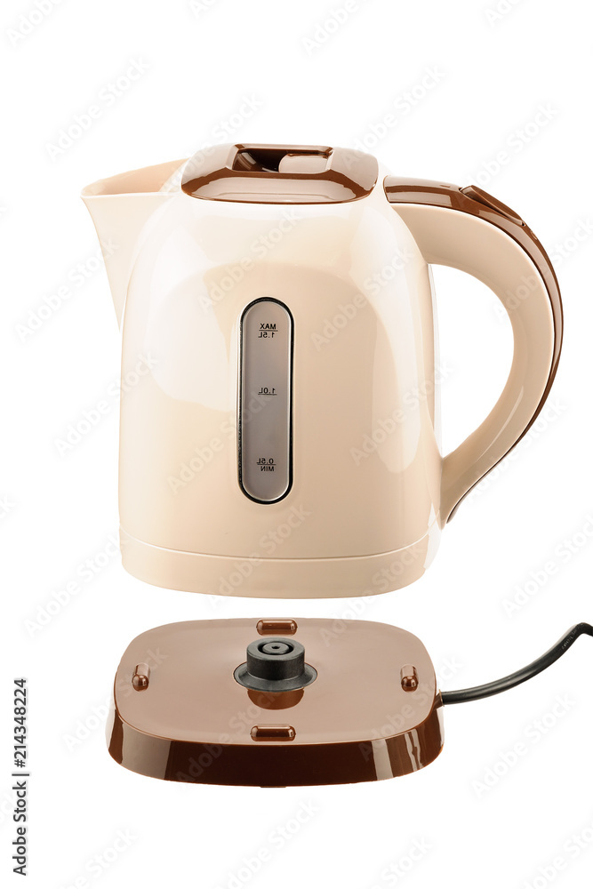 Beige plastic kettle on base isolated on white background Beige plastic kettle on base isolated on white background