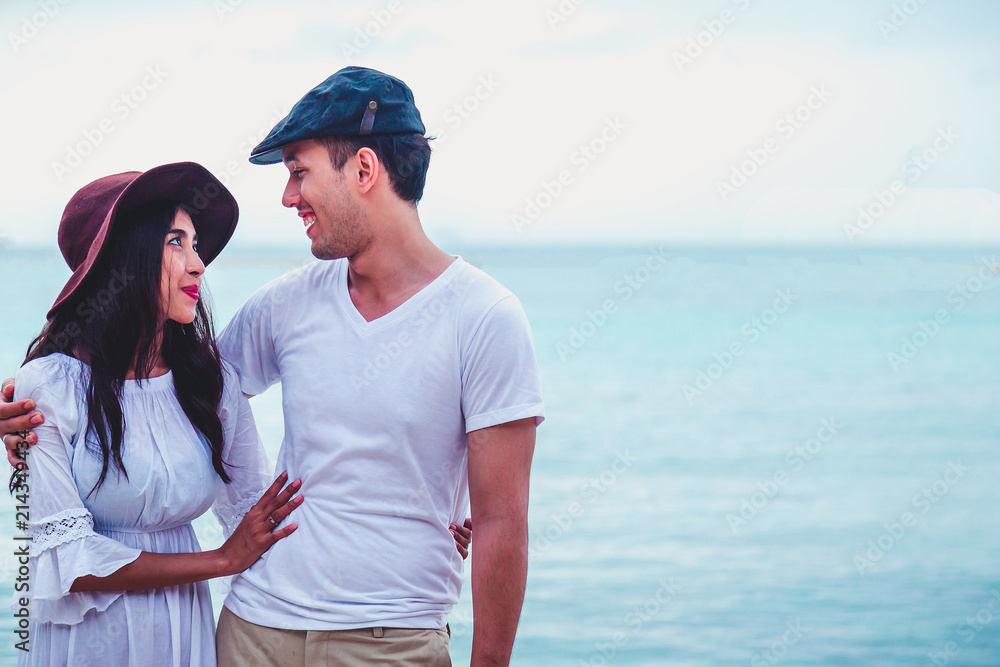 young happy couple with draw heart on tropical beach,Honeymoon Romantic couple having fun on beach.