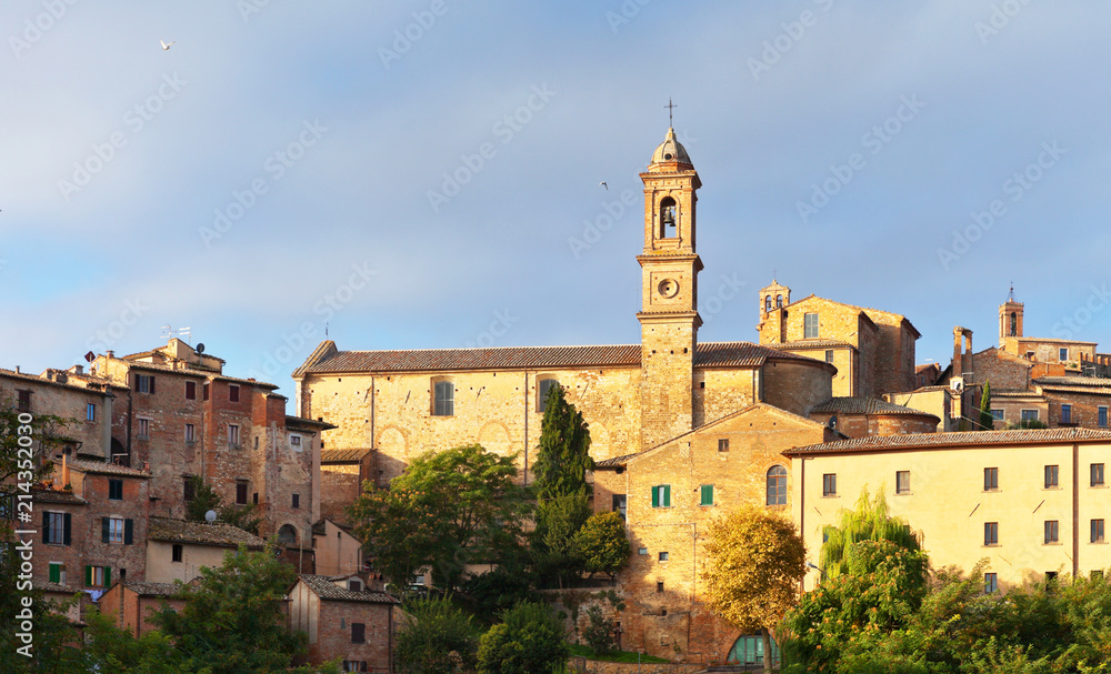 Italy. Tuscany. View on the medieval town of Montepulciano and the bell tower of S. Agostino Church at sunny September morning