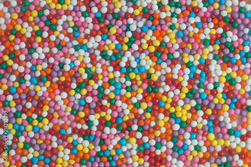 Colorful bright background of small balls for screen saver for designer. Multicolored painted grains. Ball Pool Pattern