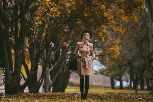Mature woman walks in the autumn park