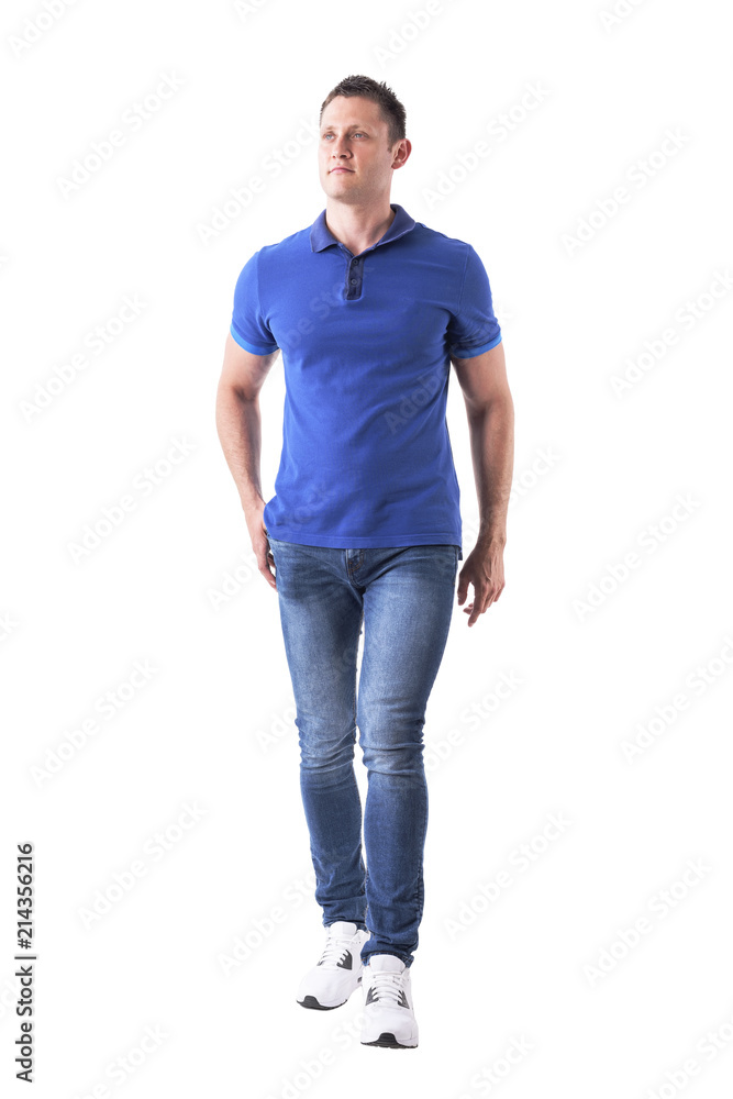 Front view of confident relaxed man walking towards camera and looking up with hand in pocket. Full body isolated on white background. Front view of confident relaxed man walking towards camera and looking up with hand in pocket. Full body isolated on white background.