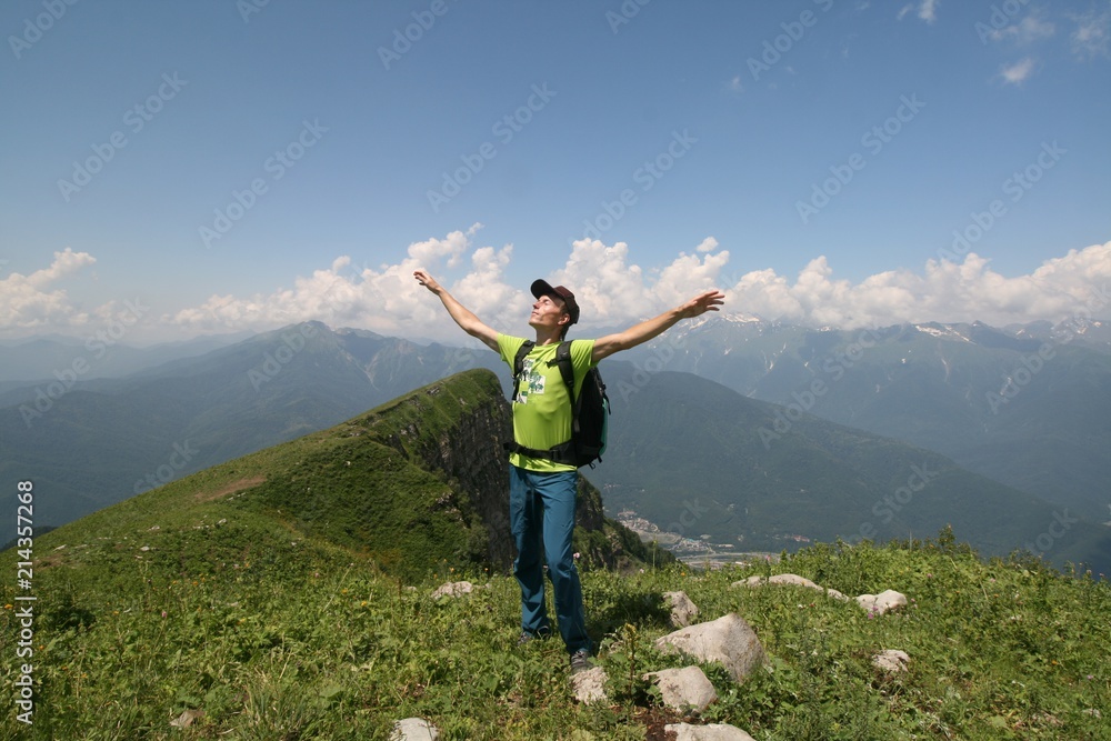 Tourist at the top of the mountain on a sunny day, the Caucasus mountains, Krasnaya Polyana