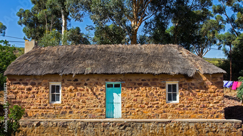 Slika na platnu Old stone thatched cottage
