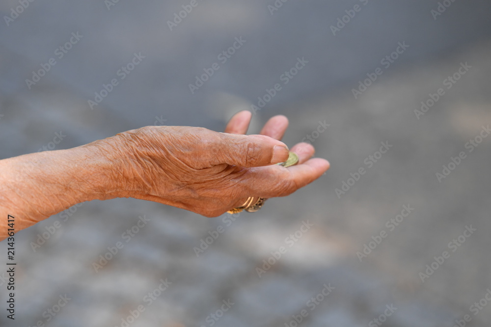 Φωτογραφία The right hand with some euro-coins of a female beggar from eastern europe