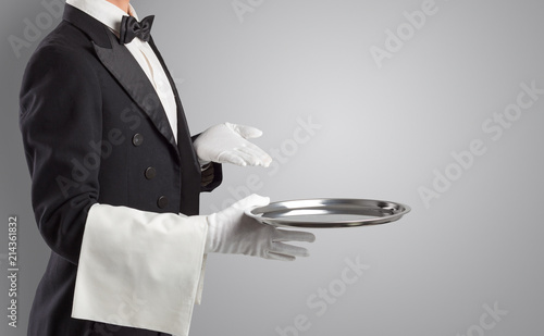 Waiter serving with white gloves and steel tray in an empty space
