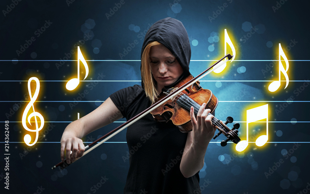 Fototapeta premium Young handsome fiddler playing with music sheet background