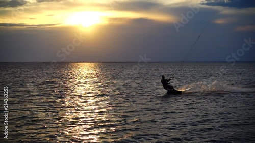 	Kite boarding. Slow motion.	Sunset over the sea.