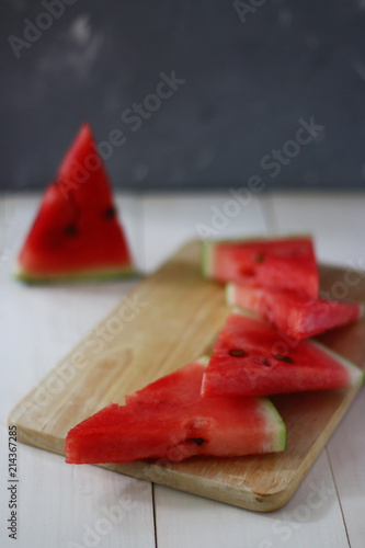 sliced watermelon on wooden deck