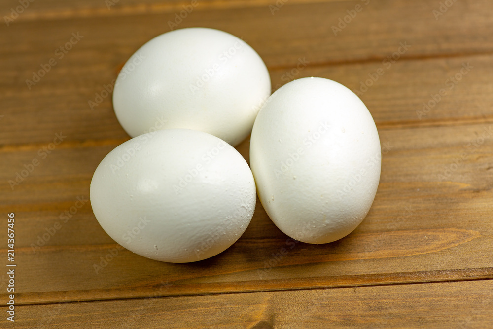 Three eggs on the kitchen table ready for frying Three eggs on the kitchen table ready for frying