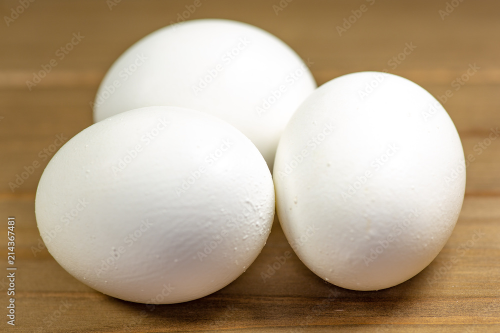 Three eggs on the kitchen table ready for frying Three eggs on the kitchen table ready for frying