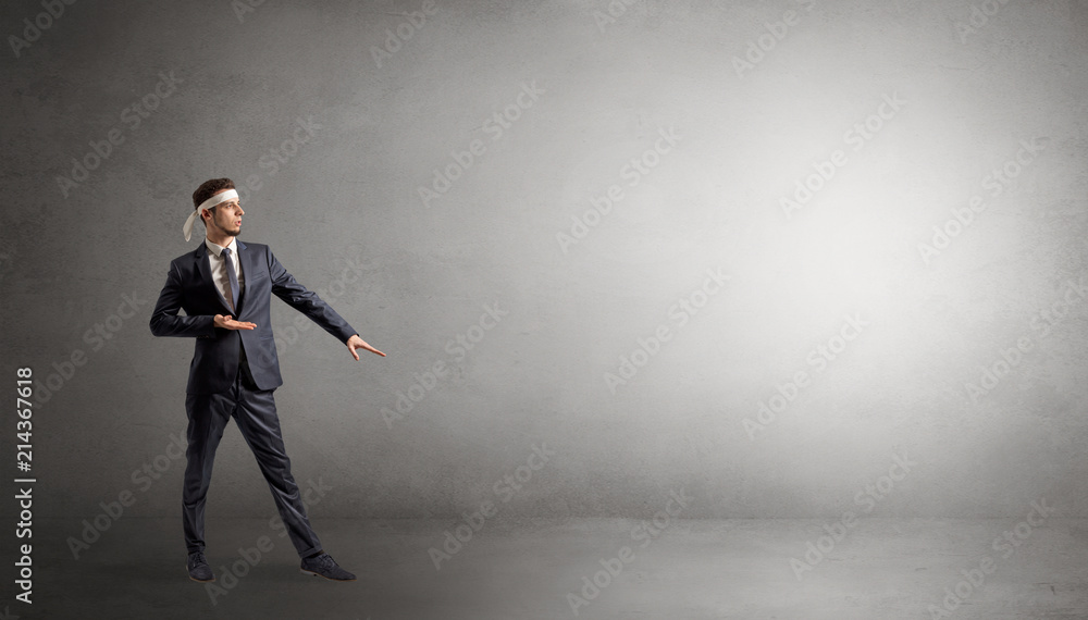 Small karate man fighting in an empty grey copy space Small karate man fighting in an empty grey copy space