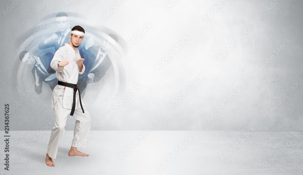 Young businessman in suit fighting with empty wall background
Young businessman in suit fighting with empty wall background