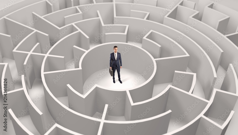Young businessman standing in a middle of a 3d round maze
Young businessman standing in a middle of a 3d round maze