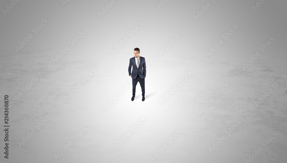 Young businessman standing alone in the middle of an empty space
