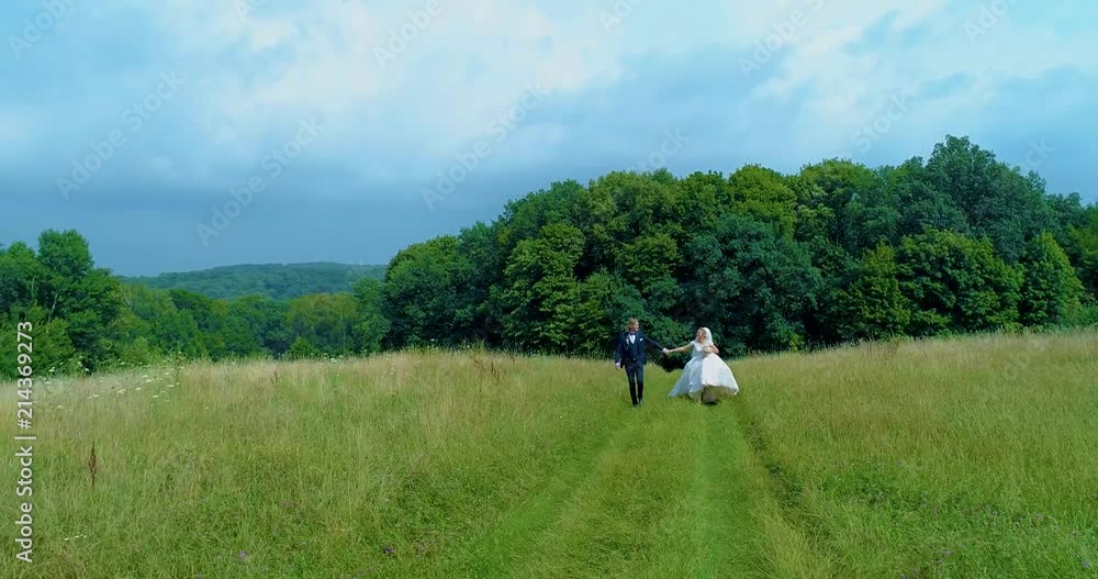 Bridesmaids running to a retro car in the nature aerial wiev move back 50p Bridesmaids running to a retro car in the nature aerial wiev move back 50p