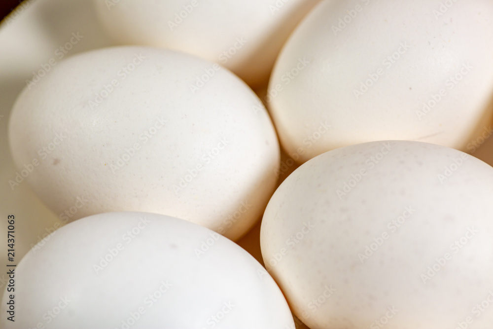 Eggs on a while plate sitting on the kitchen table waiting to be cracked Eggs on a while plate sitting on the kitchen table waiting to be cracked
