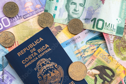 Flat lay of coin and paper currency from Costa Rica, with Costa Rican passport.  photo
