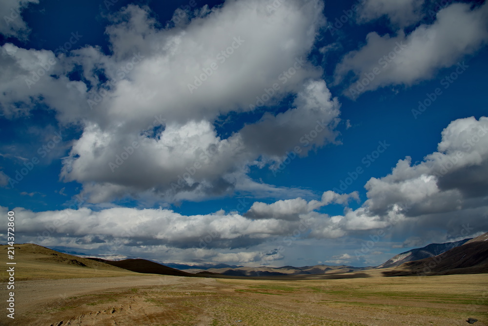 Western Mongolia. The endless steppe is surrounded by mountain ranges.