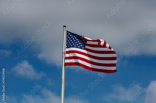 American Flag Against a Blue and Cloudy Sky