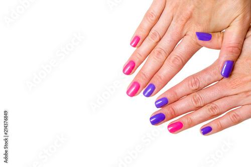 Beauty, fashion and Nail art concept. Manicure in nail spa salon -woman hands close-up with colored pink and purple gel nail polish. isolated on white background. copy space