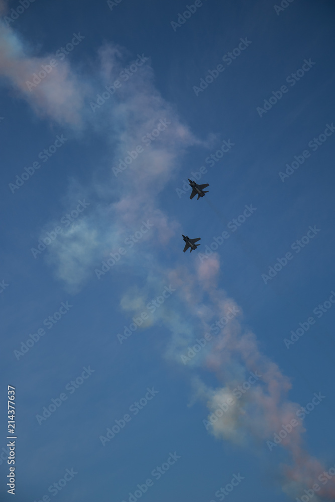 Military airplanes lined up in a row during the Russian military parade on bright blue sky with clouds in spring