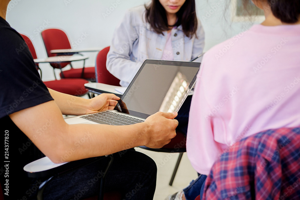 Education concept. Students studying and brainstorming campus concept. Close up of students discussing their subject on books textbooks and writing to notebook.