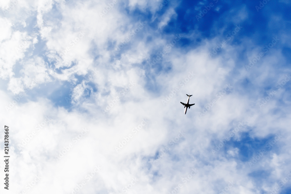 airplane flying in a cloudy sky