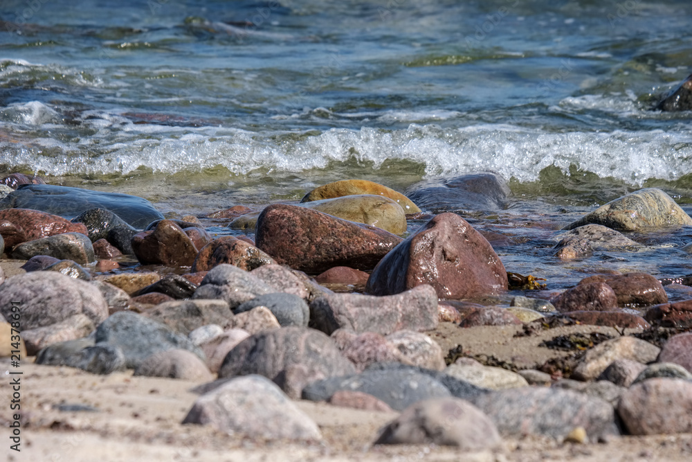 rocky sea beach with waves and sunny day rocky sea beach with waves and sunny day