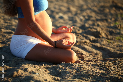 pregnant girl doing yoga sand beach sea