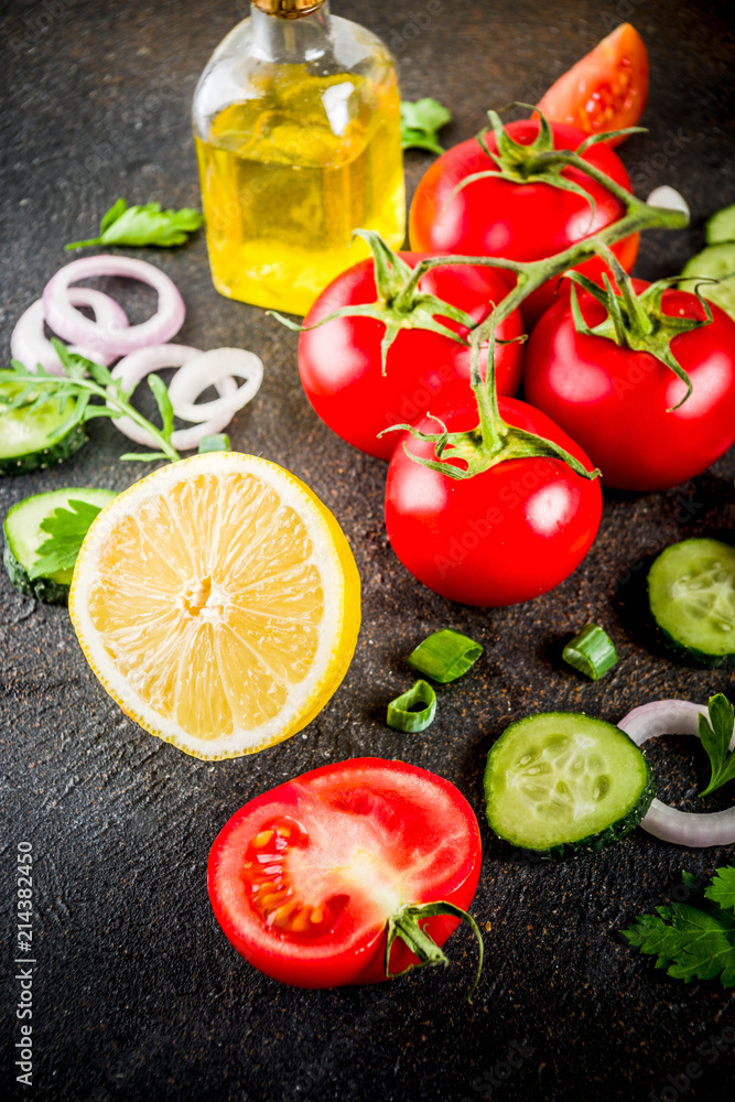 Cooking background, fresh salad ingredients, italian cuisine - tomatoes, olive oil, lemon, cucumbers, arugula, parsley, onions, Dark rusty background copy space