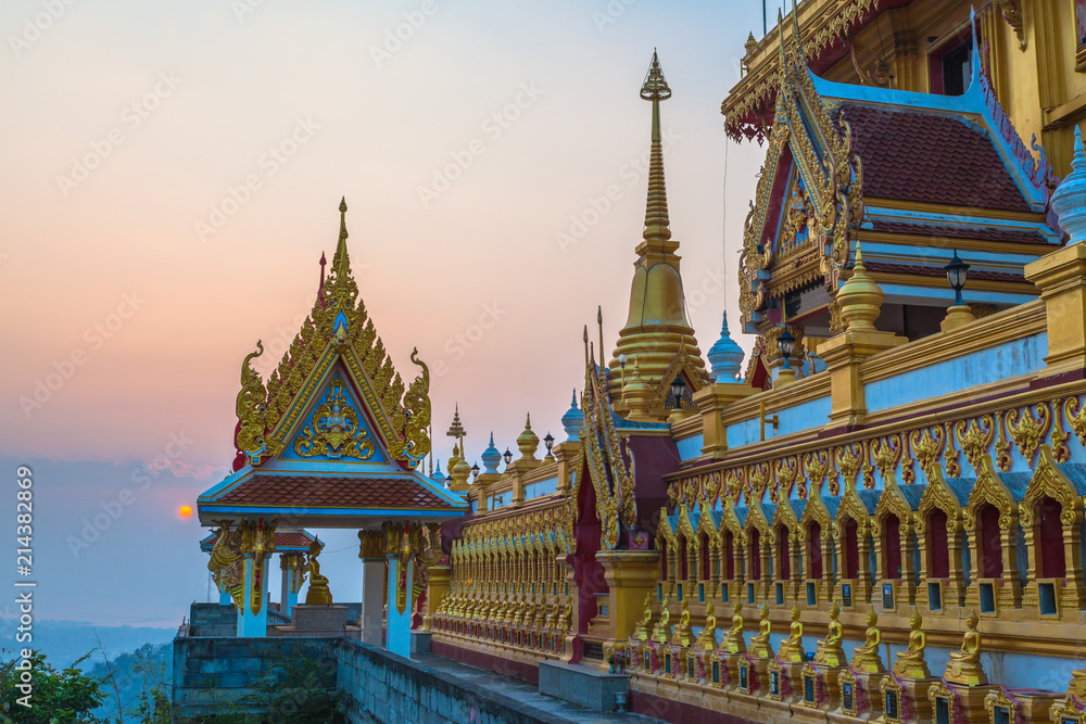 Fototapeta premium scenery sunrise above the golden pagoda on the high mountain in Kiriwong temple in Nakornsawan Thailand