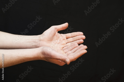 Hands ask something or give a black background