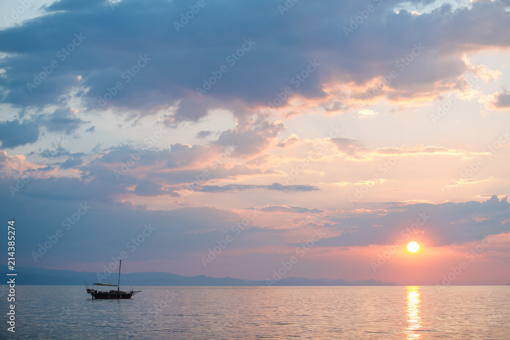 Fishing boat on the sunrise in the sea
